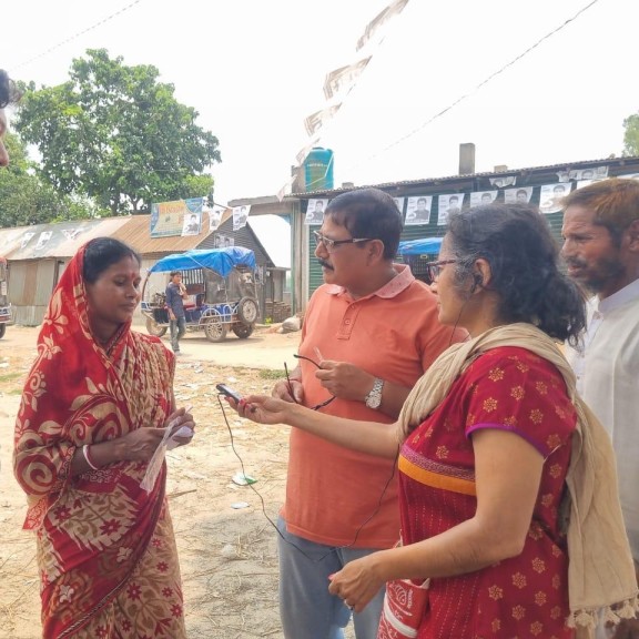 A woman interviews community members in Bangladesh