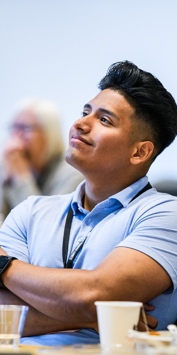 Participants in the Climate Changes Everything conference smile at the speaker