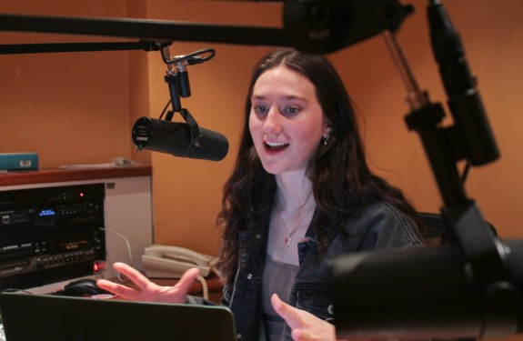 Anna Lionas speaks into a microphone