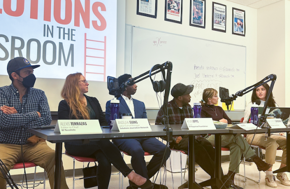 Journalists speak on a panel